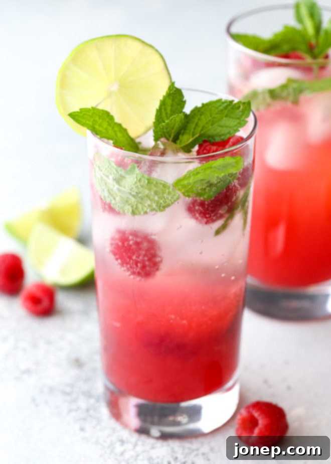 This refreshing raspberry mojito cocktail made with rum, mint, lime, and fresh raspberries is perfect for summer sipping!