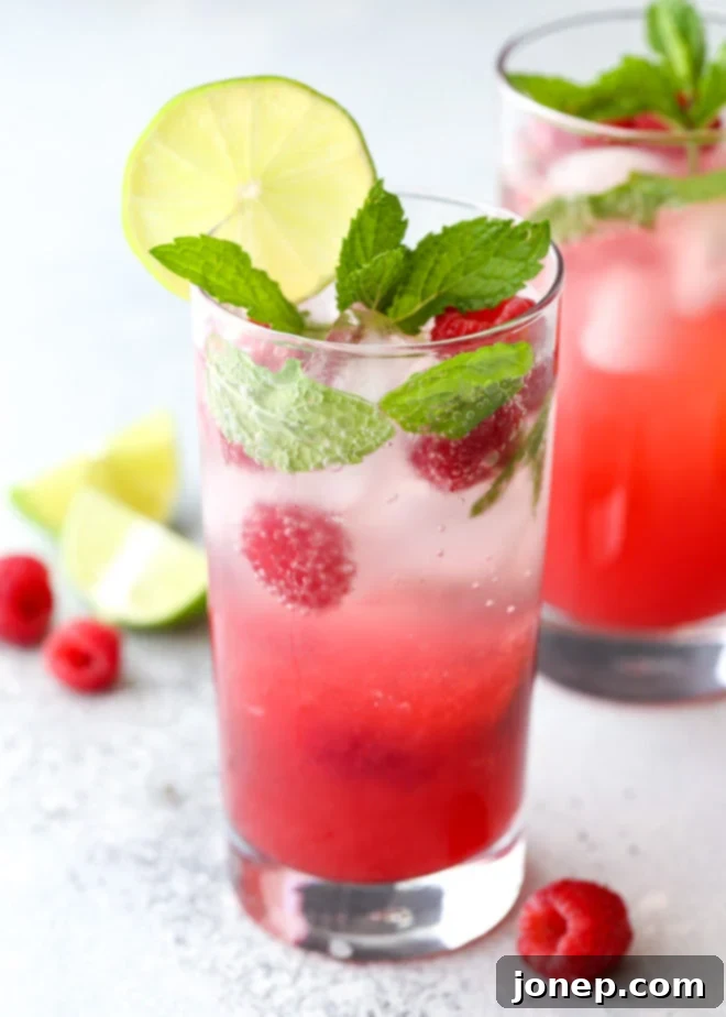 This refreshing raspberry mojito cocktail made with rum, mint, lime, and fresh raspberries is perfect for summer sipping!