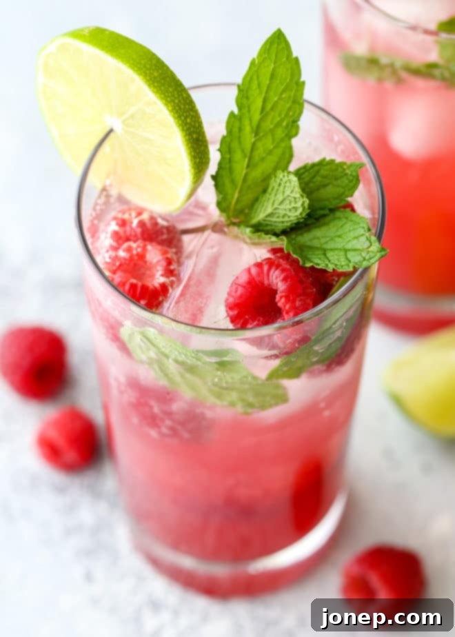 This refreshing raspberry mojito cocktail made with rum, mint, lime, and fresh raspberries is perfect for summer sipping!