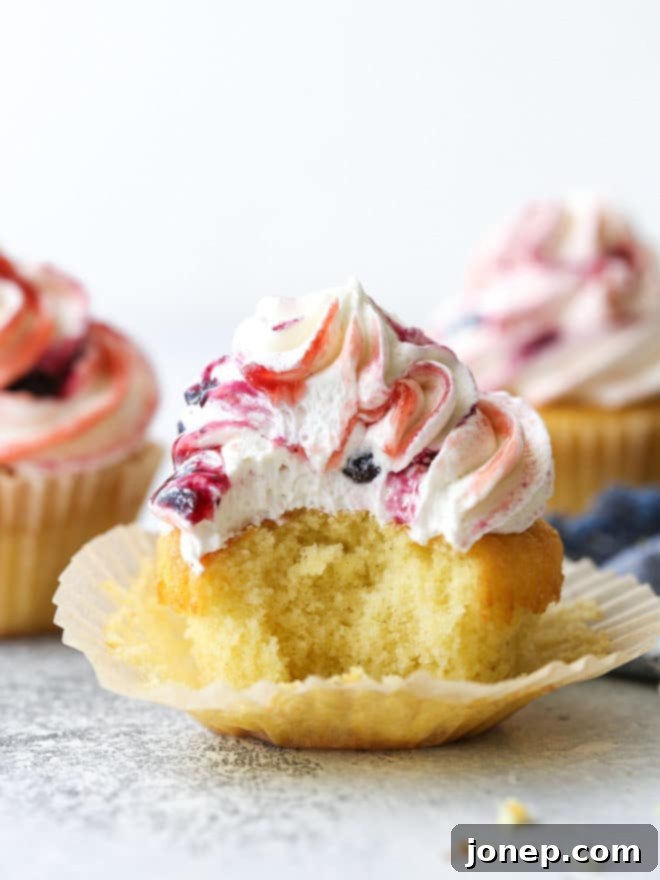 Delicate vanilla cupcakes topped with buttercream frosting swirled with berry preserves are lovely and delicious!