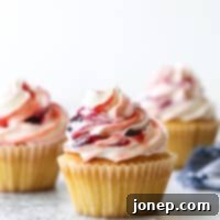 Berry Swirl Vanilla Cupcakes 7 Delicate vanilla cupcakes topped with buttercream frosting swirled with berry preserves are lovely and delicious!