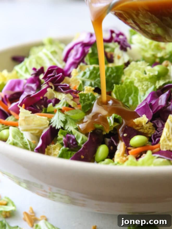 This Asian ramen cabbage salad is filled with napa and purple cabbage, shredded carrots, scallions, shelled edamame, crunchy ramen noodles, slivered almonds and a peanut sesame dressing.