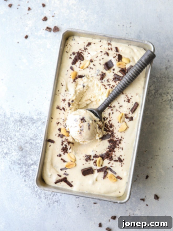 A scoop of creamy no-churn peanut butter chocolate chunk ice cream in a bowl, ready to be enjoyed.