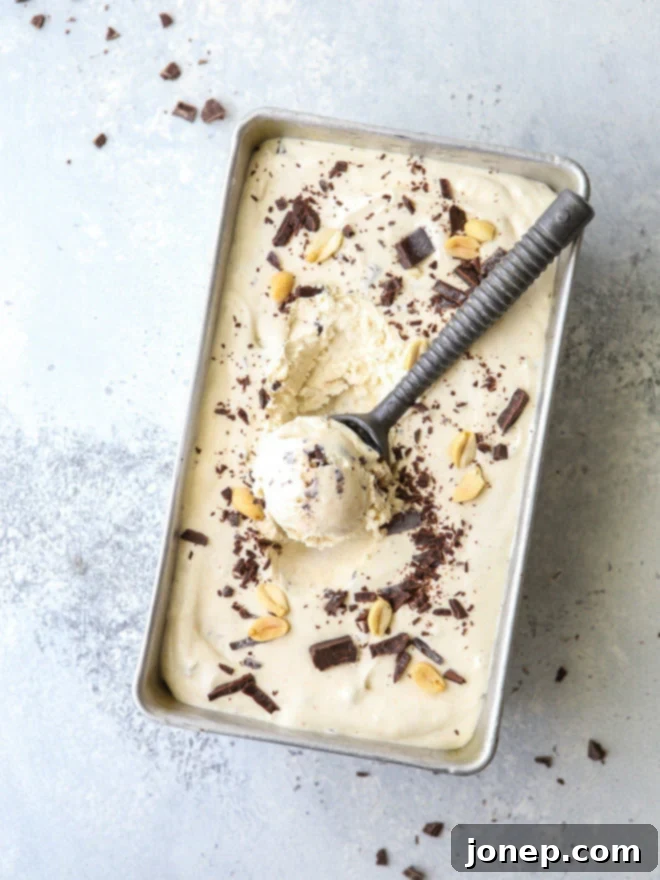 Delicious no-churn peanut butter chocolate chunk ice cream in a tub, ready to be scooped.