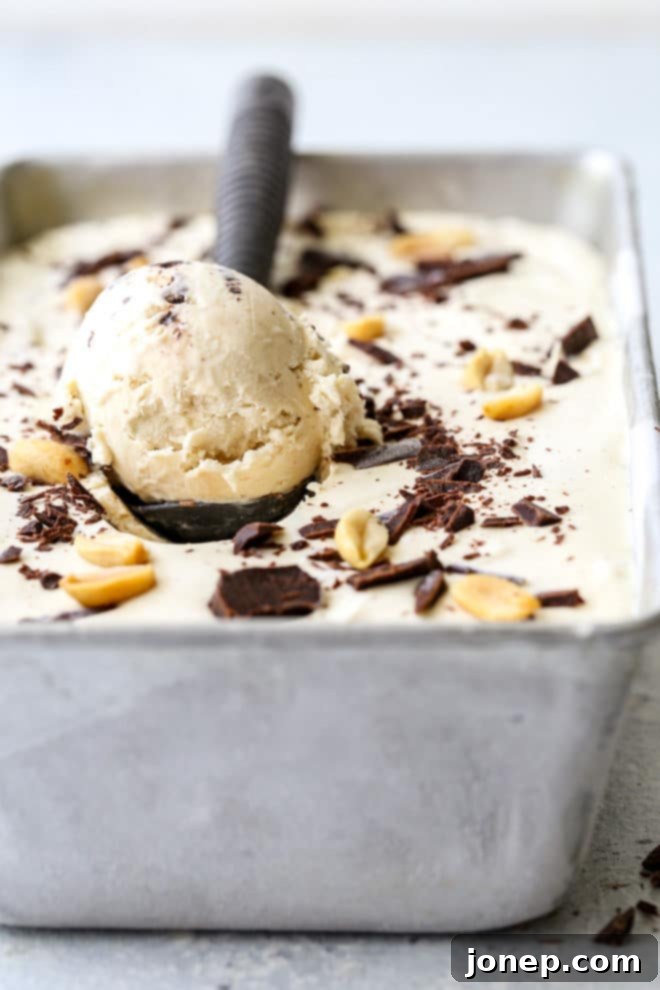 Homemade no-churn peanut butter chocolate chunk ice cream scooped into a cone