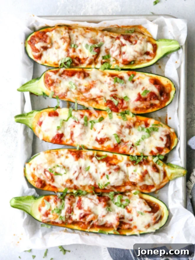 These sausage stuffed zucchini boats are cheesy and delicious, and have my whole family's stamp of approval. 