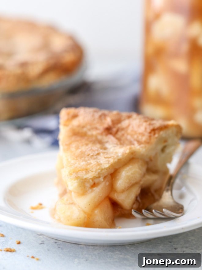 Homemade apple pie filling makes fall baking a snap! A close-up of a bubbling pie with golden crust.