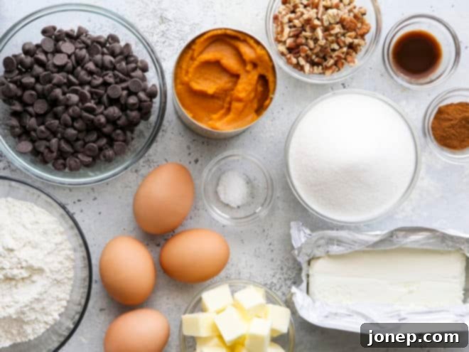 Assorted ingredients laid out on a kitchen counter, ready for making pumpkin cheesecake swirl brownies