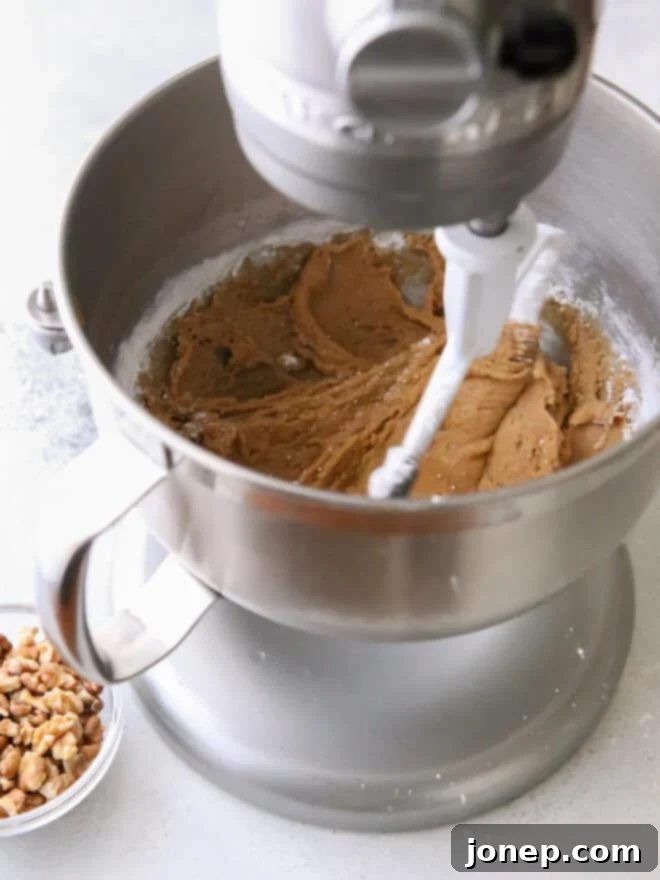 beating fudge with an electric mixer in a large bowl