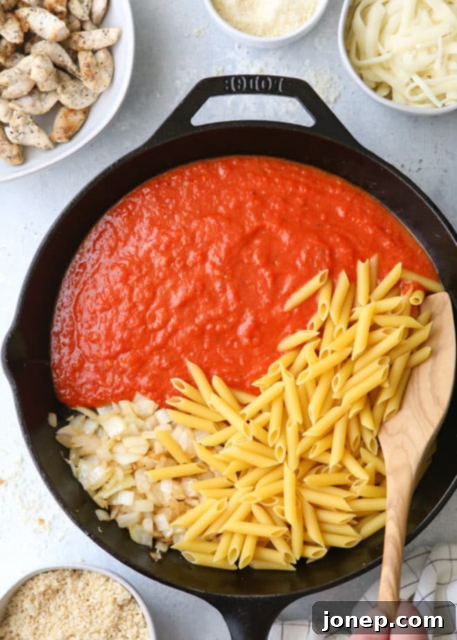 Delicious one-pot chicken parmesan pasta, ready to be served from the skillet.