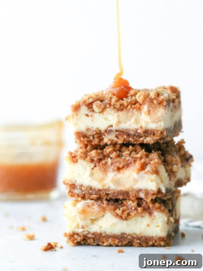 Layers of graham cracker streusel, smooth cream cheese filling, cinnamon apple chunks, and caramel drizzle make up these rich and creamy caramel apple cheesecake bars, perfect for fall baking.