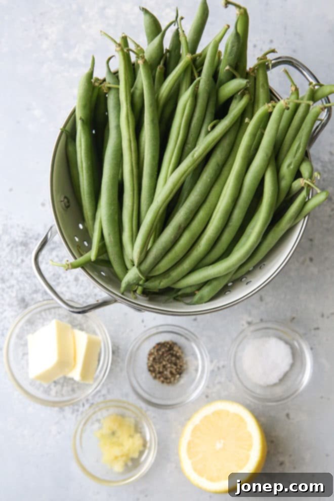 A close-up of fresh green beans and other ingredients, emphasizing that just 5 simple items are needed for these delicious buttery garlic green beans.