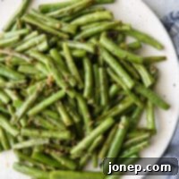 Garlic Butter Green Beans 6 Buttery Garlic Green Beans plated, ready to be served, highlighting their fresh and simple appeal.