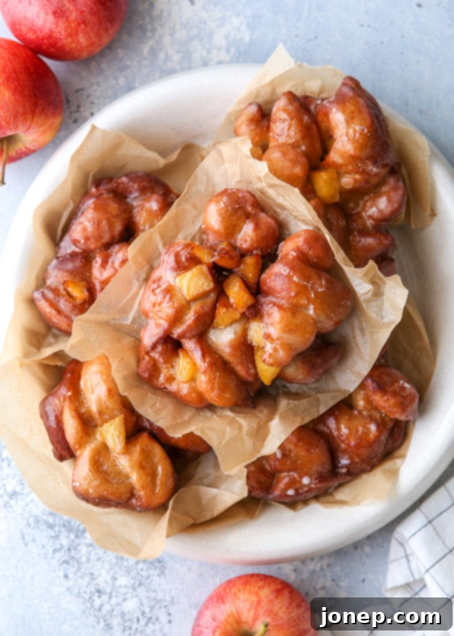 Golden Apple Delights 2 Homemade apple fritters made with yeast-risen dough folded together with juicy cinnamon apples, golden brown and ready to eat!