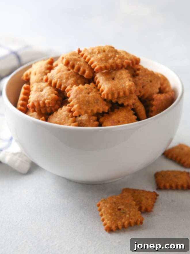 Sweet potato and cheddar crackers stacked on a white plate