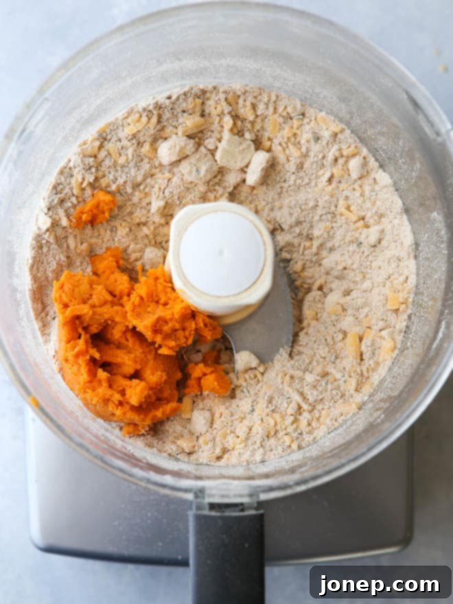 Close-up of sweet potato and cheddar cracker dough being rolled out