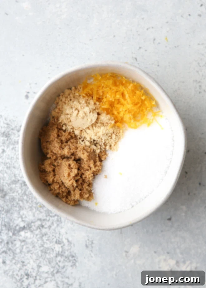 The Perfect Golden Roasted Turkey 4 Ingredients for a dry brine mixed in a bowl, showcasing coarse salt, brown sugar, lemon zest, and ground mustard.