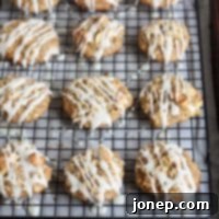 Sweet Glazed Oatmeal Apple Cookies 2 A batch of freshly baked Iced Oatmeal and Apple Cookies on a cooling rack.