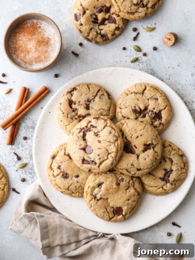 These chai spice chocolate chip cookies are thick and chewy, and loaded up with dark chocolate and warm spices like cardamom, ginger, nutmeg, cinnamon, cloves and allspice.