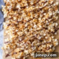 Gourmet Chocolate Caramel Corn 7 Homemade Chocolate Caramel Corn on a platter with some pieces drizzled with chocolate and sprinkled with salt.