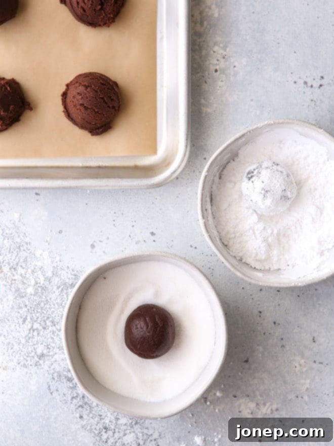 Roll cookies in granulated sugar and powdered sugar to prevent powdered sugar from absorbing into cookie