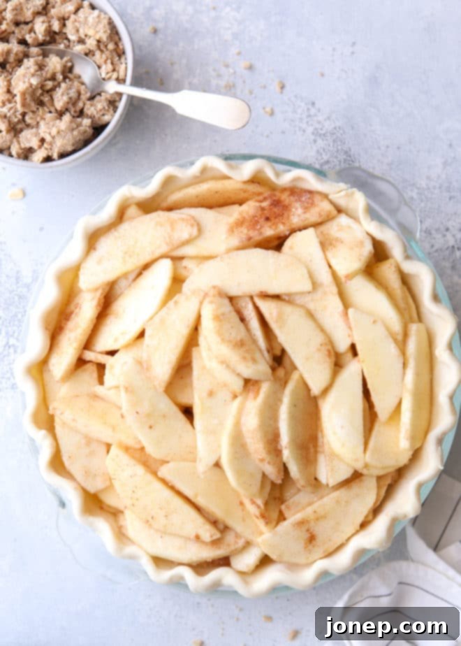 Close-up of freshly prepared apple pie filling for Dutch apple pie, showing spiced apple slices ready for baking
