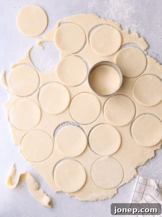 Upcycled Pie Dough Bites 3 Rolling out leftover pie dough on a floured surface for cutting into cookie shapes