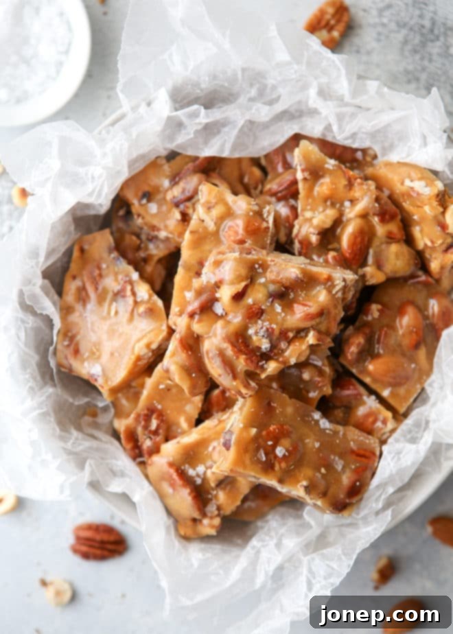 Sheet pan with freshly spread salted caramel nut brittle, ready for cooling