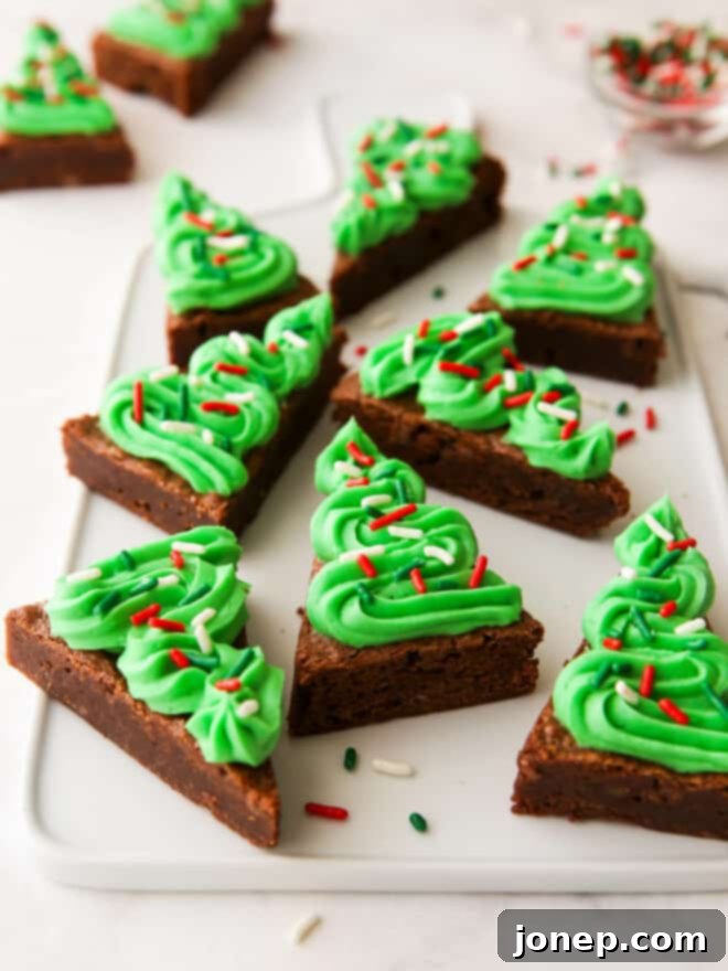 Fudgy Frosted Brownie Shapes 3 Close-up of frosted brownie Christmas trees on a white plate
