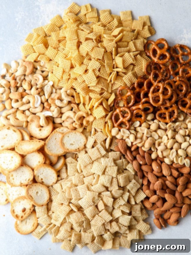 Close-up of the crunchy sweet and spicy snack mix ingredients, highlighting the golden glaze on pretzels, nuts, and cereal pieces.