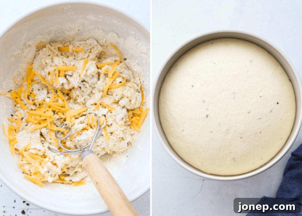 Process of mixing pretzel dough with cheese and rosemary in a stand mixer.