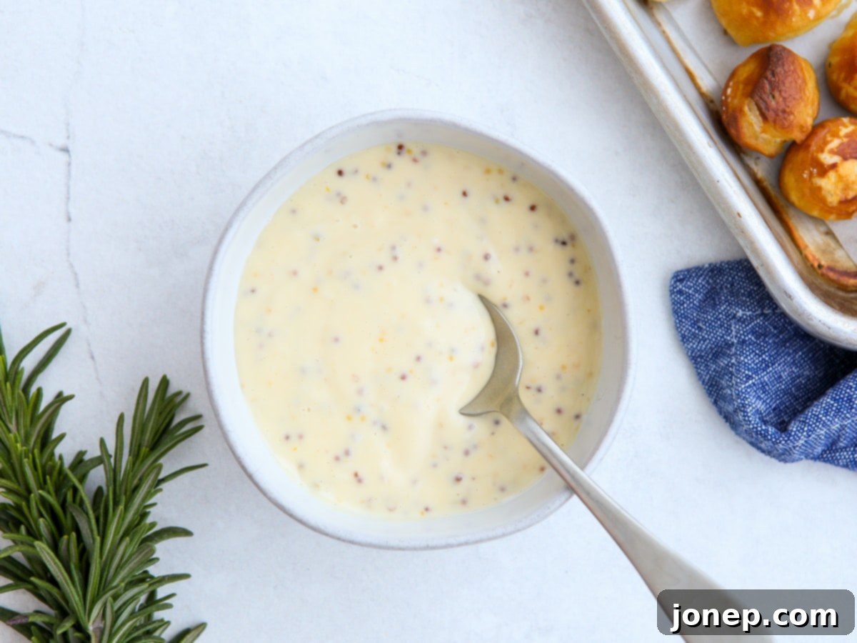 Creamy homemade honey mustard dipping sauce in a small ceramic bowl.