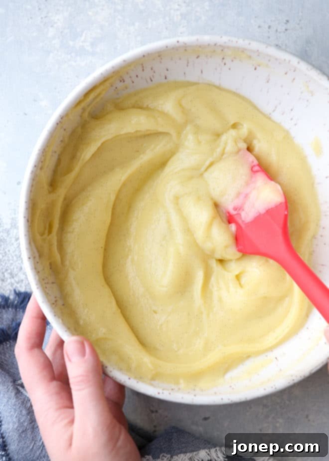 Ingredients for no-bake crème brûlée laid out, including vanilla bean, cream, milk, sugar, egg yolks, and cornstarch.