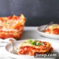 This classic meat lasagna is filled with layers of pasta, homemade meat sauce, and lots of ricotta, mozzarella, and parmesan cheese.
