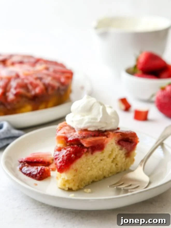A beautiful strawberry rhubarb upside-down cake, showing the caramelized fruit topping.