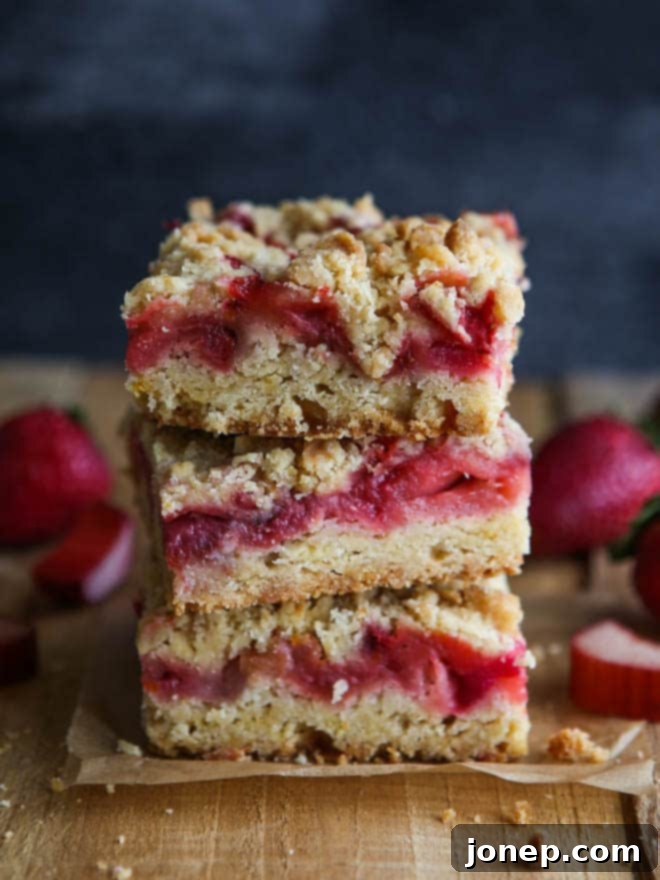 Delicious strawberry rhubarb crumb bars, perfect for a spring dessert or snack, with a crumbly top.