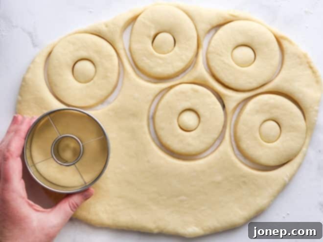 rolling out and cutting doughnuts