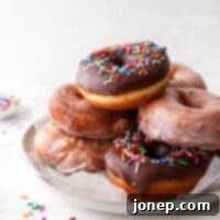 yeast-raised doughnuts stacked on a plate