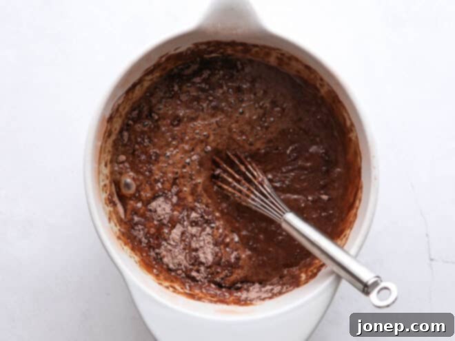 When to Use Baking Powder or Baking Soda 2 Close-up of chocolate cupcake batter being mixed in a bowl, showing a smooth, creamy texture.