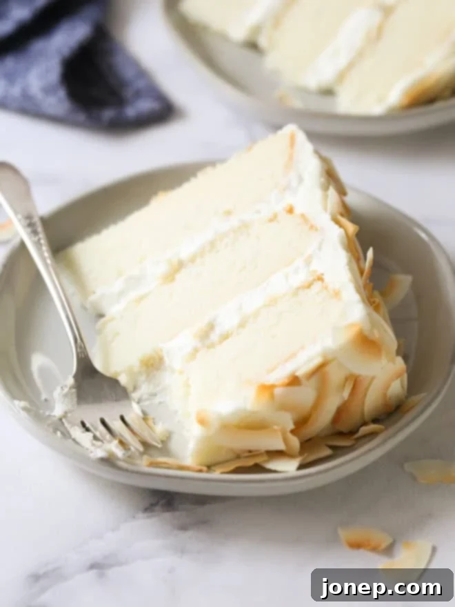 When to Use Baking Powder or Baking Soda 4 A slice of Southern Coconut Cake being taken, revealing light and fluffy layers.