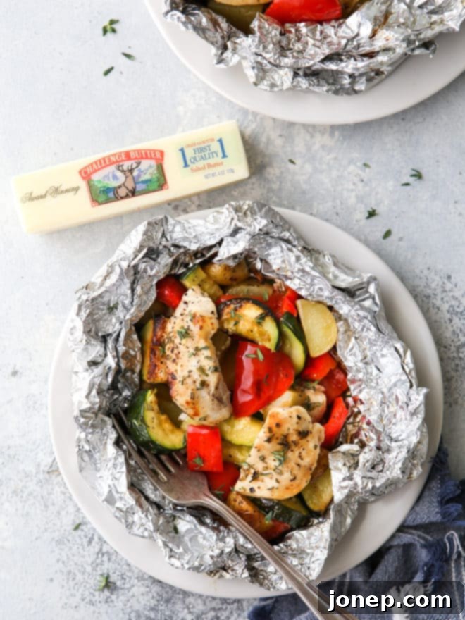 A perfectly cooked chicken and veggie tin foil dinner, opened and ready to eat