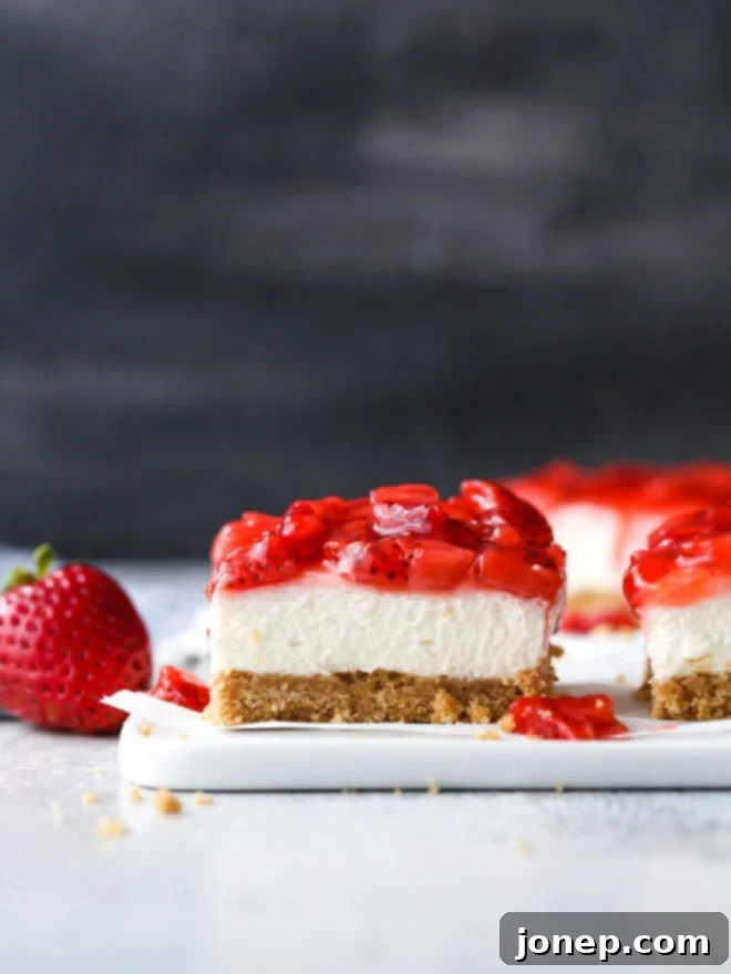 Delightful no-bake strawberry cheesecake bars, a perfect summer treat.