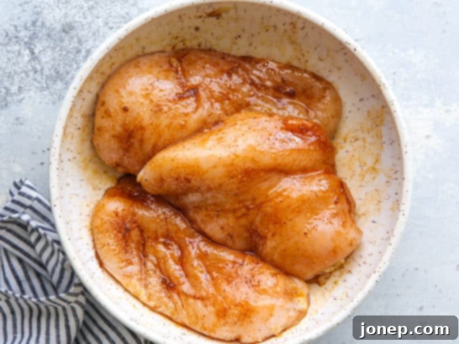 Boneless chicken breasts marinated with spices, ready for grilling or slow cooking