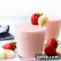 strawberry banana smoothie in cup with fruit