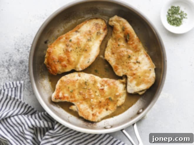 chicken with herb butter sauce in a skillet