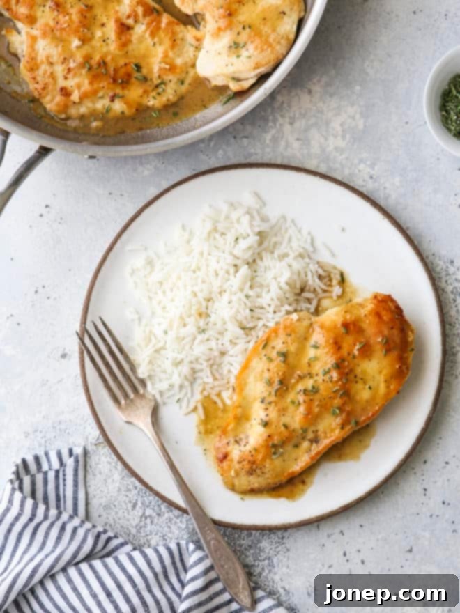 easy skillet chicken with herb butter sauce on a plate with rice