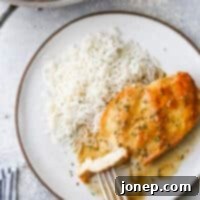 One-Pan Herb Butter Chicken 8 taking a bite of skillet chicken with sauce and rice