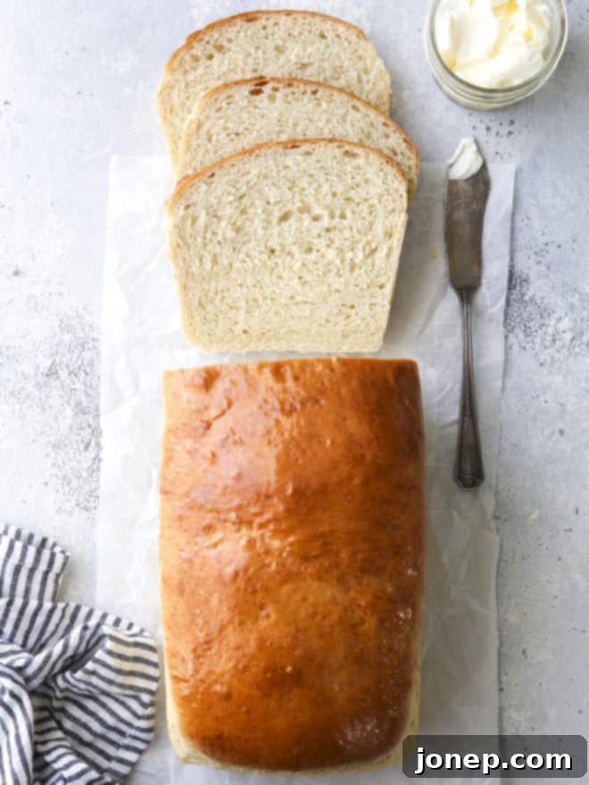Soft white sandwich bread sliced on a cutting board, ready for enjoyment
