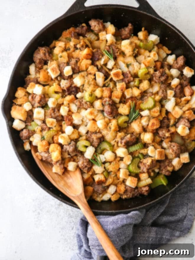 spoon in skillet stovetop sausage stuffing, showcasing the delicious homemade dish