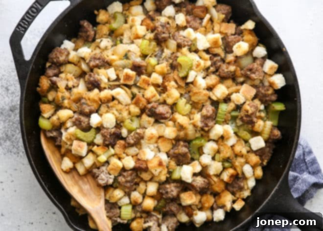 spoon in skillet stovetop sausage stuffing, close-up of the delicious texture